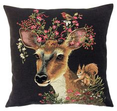 a cushion with a deer and squirrel on it's face, surrounded by flowers