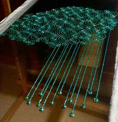 green beads hanging from the side of a window