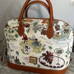 New With Tags Attached Dooney & Bourke Handbag With Detachable Shoulder Strap. Features Characters And Quotes From Disney Pixar Films. Bag Shown In The Photos Is The Exact Bag You Will Receive. No Dust Bag For This Item. Price Firm. Shipped With Care From My Pet Free And Smoke Free Home. Disney Bags For Daily Use, Daily Disney Style Bag, Disney Rectangular Shoulder Bag For Travel, Disney Satchel Bag For Everyday Use, Disney Style Rectangular Shoulder Bag For Travel, Disney Style Shoulder Bag For Travel, Disney Style Travel Shoulder Satchel Bag, Disney White Bags For Disney Trips, Disney Travel Bags With Detachable Strap