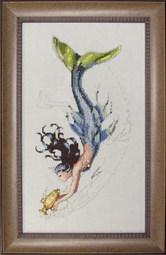 a cross - stitch picture of a mermaid and a frog swimming in the water with their tails curled up