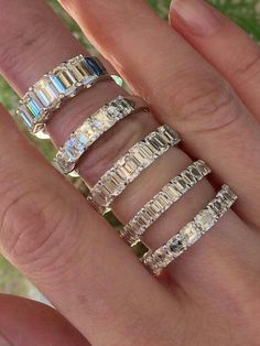 a woman's hand with five different sized rings on top of her finger,