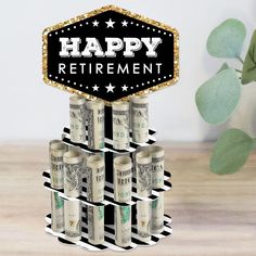 there is a sign that says happy retirement on top of money stacks in front of a potted plant