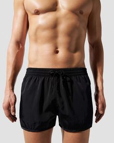 Our Swim Shorts in smooth satin twill are designed with a regular fit, short leg and mesh lining for comfort and support. Made of Econyl®—a nylon fibre repurposed from landfill and ocean waste. Regular fit, short length Inside leg length size M 6.5 cm/2.6" If between sizes, consider taking sizing down Model is 176 cm/ 5’9’’and wears size M Mesh lining for comfort and support Elastic waistband with drawstring Side seam pockets and back zip pocket for secure credit card storage Tonal embroidered C Nylon Shorts With Elastic Waistband, Nylon Gym Bottoms In Solid Color, Solid Color Nylon Shorts, Solid Nylon Short Bottoms, Relaxed Fit Black Beachwear Bottoms, Black Relaxed Fit Beachwear Bottoms, Nylon Bottoms With Elastic Waistband, Nylon Bottoms With Elastic Waistband, Short Length, Black Nylon Beach Bottoms