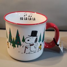 a red and white coffee cup with a cartoon character on it