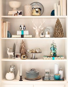 a white book shelf filled with lots of books and other items on top of it