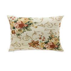 a white pillow with flowers and vines on the front, sitting against a white background