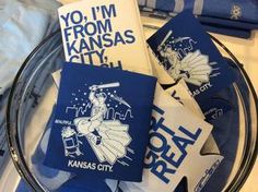 kansas city coasters sitting on top of a glass plate next to folded towels and napkins