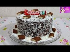 a chocolate cake with white frosting and candies on top