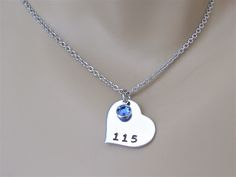 Police Wife, Police Mom, Police Daughter Hand Stamped Heart Necklace with Custom Badge Number and Blue Swarovski Crystal. The aluminum pendant is one inch. Aluminum will not tarnish and has the look of silver but much more affordable and is hypoallergenic. Aluminum is very light weight. The piece pictured is a representation of that your piece will look like. Each letter and design is individually stamped by hand, and as such every piece I make is slightly different. This includes the spacing an Blue Heart Charm Necklace For Wedding, Blue Heart Necklace With Heart Charm For Wedding, Blue Heart-shaped Necklace For Birthday, Heart Shaped Blue Jewelry For Birthday, Police Daughter, Police Mom, Wife Necklace, Police Wife, Daisy Studs