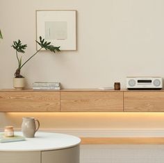 a living room with a table and some plants