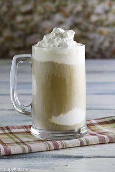 there is a cup of coffee with whipped cream on top