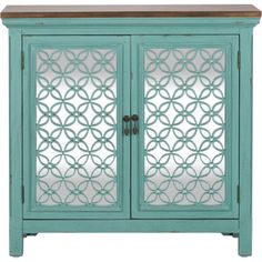 a blue cabinet with glass doors on the front and side panels in an intricate pattern