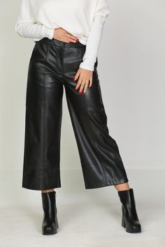 "These faux leather pants are a true symbol of elegance and retro style, inspired by the unique era of the 90s. Its calf-length length lends a casual yet impactful charm. The front zip fastening and hidden button ensure a perfect fit and accentuate the contours of the body. The front pockets add practicality, while the masterfully recreated back pockets are an elegant imitation with subtle detailing on the fillets. The slightly flared legs with the front decorative seam give the trousers character and uniqueness. Made of supple and soft synthetic leather, it provides all-day comfort and freedom of movement. The possibility to choose from several colors makes it a universal choice for any fashion combination. This pant is a true symbol of aesthetics and style that brings to life the spirit Trendy Wide-leg Leather Pants, Elegant Faux Leather Wide Leg Pants For Fall, Trendy Wide Leg Leather Pants, Wide-leg Leather Pants For Party, Wide Leg Leather Pants For Party, Elegant Faux Leather Pants With Belt Loops, Elegant Wide Leg Faux Leather Pants, Spring Formal Faux Leather Bottoms, High Waist Faux Leather Formal Bottoms