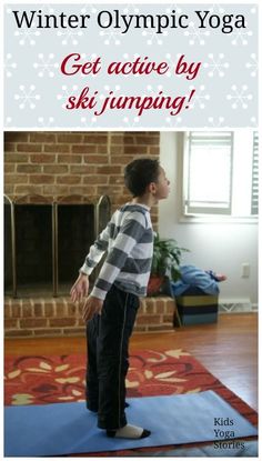 a young boy standing on top of a blue mat in front of a fire place