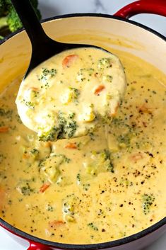 broccoli and cheese soup in a pot with a ladle