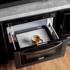 a coffee cup is sitting in an open drawer