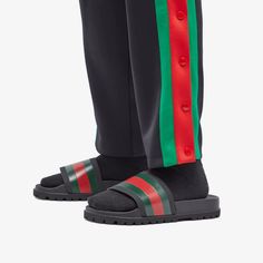 Whether you’re lounging by the pool, hitting the beach or laying low at home, Gucci has your footwear covered with these black slides. The rubber uppers feature one of the label’s most iconic house codes - the green and red web belt - and feature moulded soles for maximum comfort..Rubber Upper.Moulded Footbed.Rubber Sole.Made in Italy Casual Green Slides With Rubber Sole, Green Slides For Streetwear With Branded Insole, Gucci Slides For Summer Beach, Gucci Casual Beach Slides, Gucci Casual Sandals With Cushioned Footbed, Gucci Slides With Cushioned Footbed For Beach, Casual Gucci Sandals With Cushioned Footbed, Gucci Casual Slides For Summer, Casual Gucci Slides For The Beach