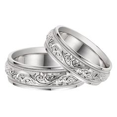 two wedding bands with intricate engraving on them