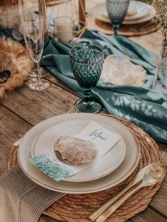 a table set with plates, silverware and napkins