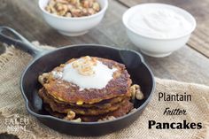 pancakes in a pan with yogurt and walnuts on the side for breakfast