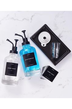 three different types of soaps and hand washes on a marble counter top,