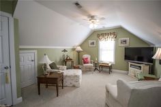 a living room filled with furniture and a flat screen tv