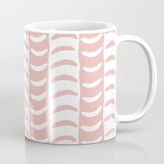 a pink and white coffee mug with wavy lines on it's side, in front of a plain background