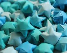 blue and white origami stars are scattered on top of each other in this close up photo