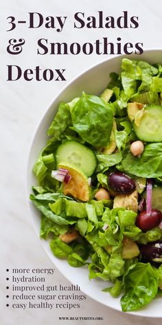 a white bowl filled with lettuce, cucumber and other food items