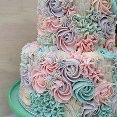 a multi - layered cake decorated with pastel flowers