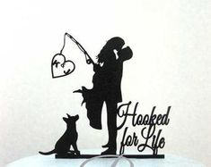 a cake topper with a silhouette of a man and woman fishing