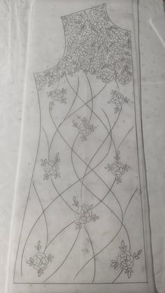 a piece of paper that is on top of a sheet of white paper with flowers and vines