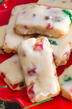 some cookies are on a red plate with white icing