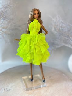 a barbie doll wearing a bright yellow dress