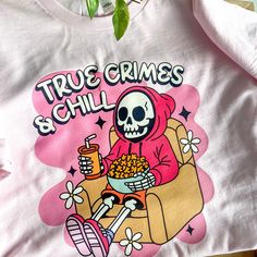 👻🎃👻 Ghouls (girls) just wanna have fun and wear cute spooky season tees🥰 #truecrimejunkie #truecrimefan #spookyseason #halloweenvibes #spookygirl #spookygirlsdoitbetter #spookyvibes #stayspooky #halloween365 #halloweenallyear #truecrimeandchill #truecrimeaddict #truecrimeobsessed #cozy #cozyvibes #thisishalloween #smallbusiness #smallbiz Novelty Long Sleeve T-shirt With Graphic Print, Long Sleeve Graphic Tee With Skull Print, Pop Culture Crew Neck Top With Funny Print, Pop Culture Screen Print Tops For Fall, Cotton Crew Neck Top With Pop Culture Style, Trendy Cotton Skull Print Tops, Trendy Long Sleeve Tops With Skull Print, Halloween Novelty Streetwear Top, Halloween Pop Culture Tops With Character Print