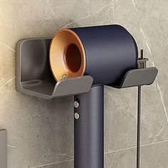 a toilet paper dispenser mounted to the side of a wall with a cup in it