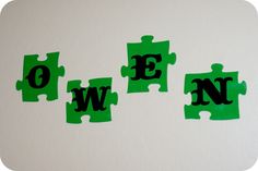 three pieces of green puzzle with the letters e, w, and f on them