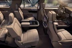 the interior of a vehicle with beige leather seats