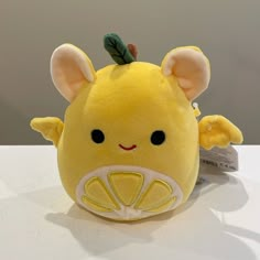 a yellow stuffed animal with ears and eyes