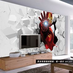 a living room with a tv and iron man wall mural on the side of it