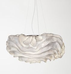 a white light fixture hanging from a ceiling