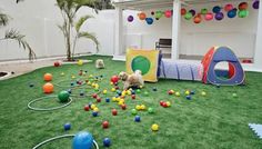 the dog is playing with his toys in the back yard at this house, which has been decorated with colorful balls