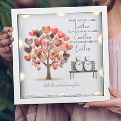 a woman holding up a framed photo with hearts on it that says our love is in the air