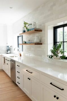 a kitchen filled with lots of white counter top space