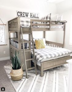 a bedroom with bunk beds and a rug on the floor in front of it that says crew hall