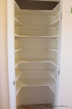 an empty white pantry with shelves and no door on the inside, in a home