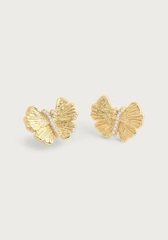 These hand sculpted butterfly studs are crafted in 18k gold dipped brass and accented with hand-set crystals. These beautiful and exquisitely made earrings are timeless addition to your everyday wardrobe. Add a touch of elegance and sparkle to your outfit with these hand-crafted butterfly studs. Made with 18k gold dipped brass and adorned with hand-set crystals, these earrings are a luxurious must-have for your everyday look. 18K Gold Plated Brass Crystal 0.7" L x 0.5" H Stud Gold Earrings, Real Butterflies, Ginkgo Leaves, Butterfly Earrings Stud, Butterfly Jewelry, Gold Dipped, Sparkling Crystal, Bridal Shop, Everyday Wardrobe