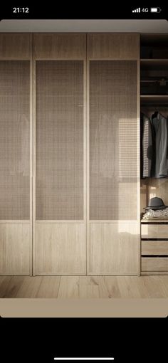 an image of a walk in closet with sliding doors and clothes hanging on the shelves