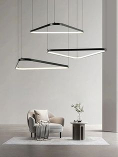 a living room filled with furniture and lights hanging from the ceiling next to a chair