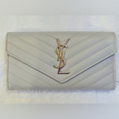 Beautiful Crme Leather Ysl Wallet With Gold Tone Hardware. Authentic In Excellent Condition. No Signs Of Wear. Comes With Her Original Box And Dust Bag. Bags Ysl, Ysl Wallet, Saint Laurent Bags, Yves Saint Laurent Bags, Yves Saint Laurent, Original Box, Saint Laurent, Dust Bag, Gold Tones